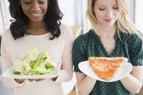 Women eating pizza and salad