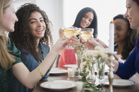 Women toasting each other with champagne