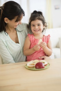 Hispanic mother and daughter eating together