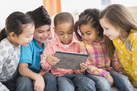 Children using digital tablet together