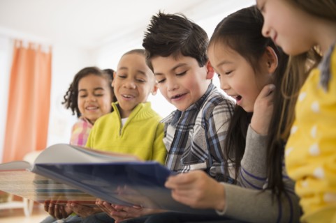 Children reading together in living room