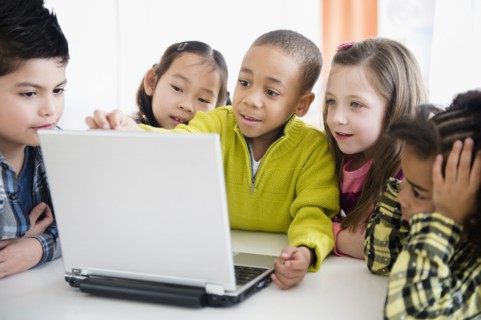 Children using laptop together