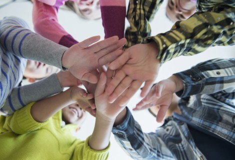 Children cheering in huddle