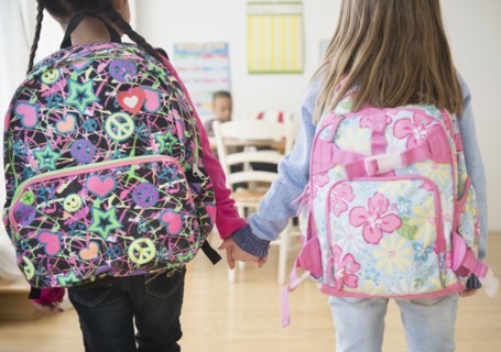 Students holding hands in classroom