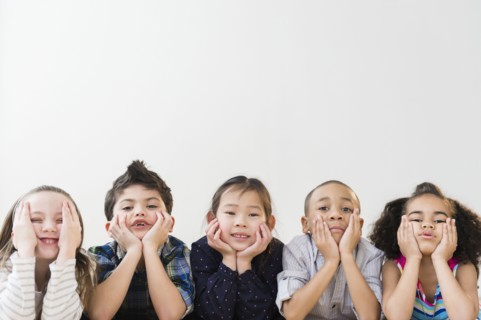 Children resting chins in hands
