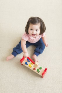 Hispanic toddler with Down syndrome playing