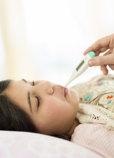 Hispanic girl taking her temperature
