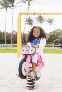 Mixed race girl playing on playground