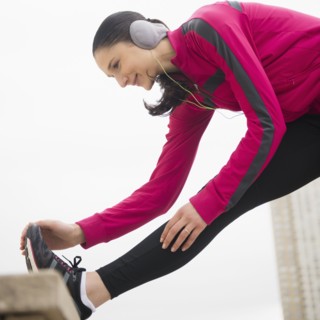 Caucasian woman stretching leg