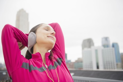Caucasian woman stretching in city