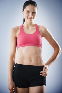 Caucasian woman with bare stomach wearing sports clothing