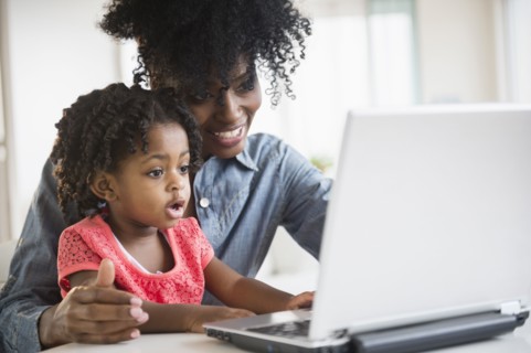 Mother and daughter using laptop