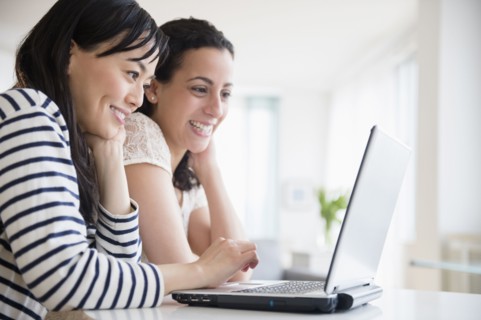 Women using laptop together