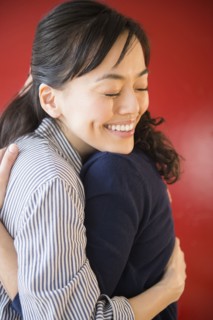 Smiling women hugging