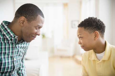 Father and son making faces at each other