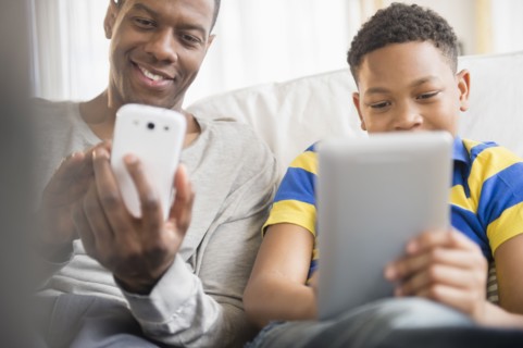 Father and son using technology together