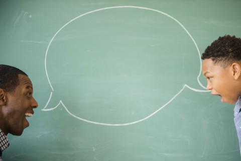 Teacher and student talking by empty speech bubble
