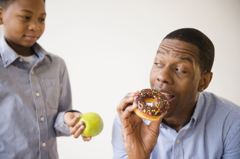 Boy offering father healthy snack