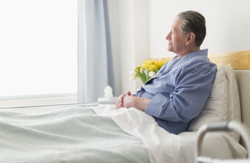 Senior Caucasian man sitting in hospital bed