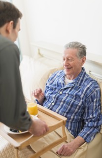 Senior Caucasian man having breakfast in bed