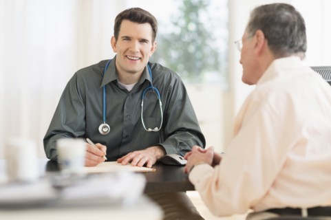 Caucasian doctor and patient talking in office