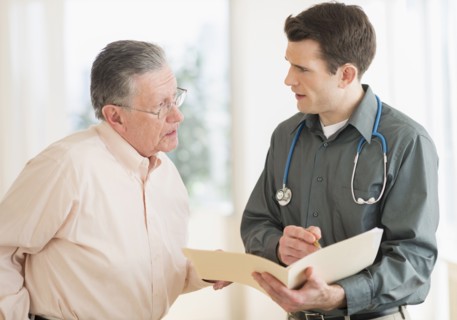 Caucasian doctor and patient talking in office