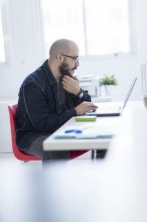 Hispanic businessman working at desk