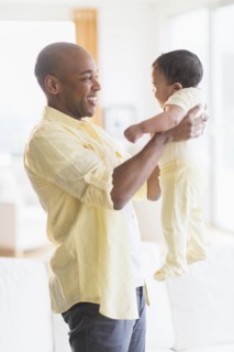 Smiling father holding baby