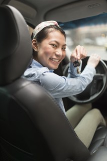 Mixed race teenage girl holding keys to car
