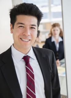 Mixed race businessman smiling in office
