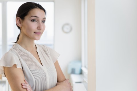 Caucasian businesswoman standing in office