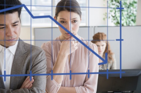 Business people examining graph on window