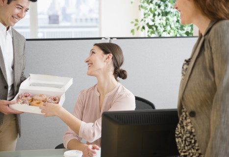 Business people having donuts in office
