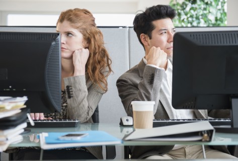 Business people bored at desks