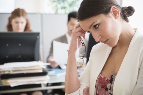 Businesswoman scratching her head in office