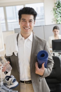Businessman carrying workout gear in office