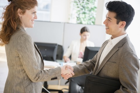 Business people shaking hands in office