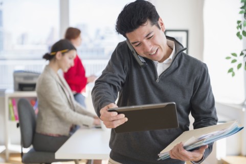 Businessman talking on cell phone in office