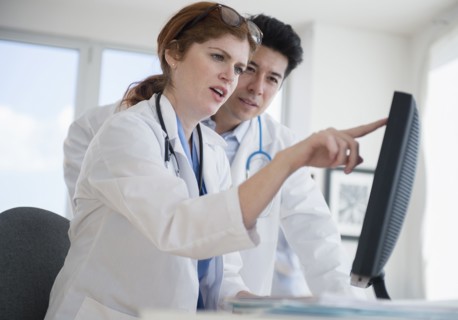 Doctors using touch screen computer in office