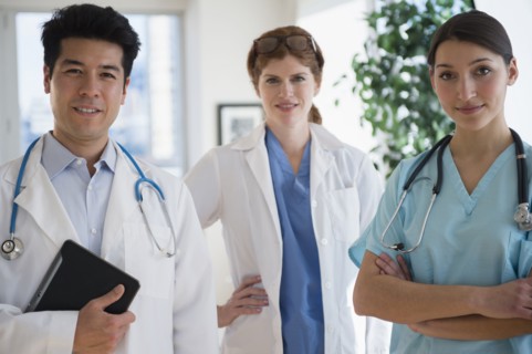 Doctors and nurse smiling in office
