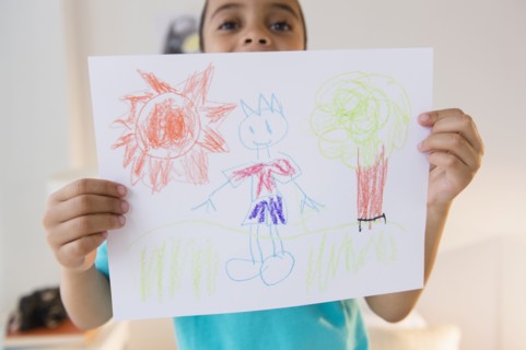 Mixed race boy displaying drawing