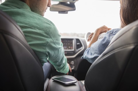 Couple with cell phone in car