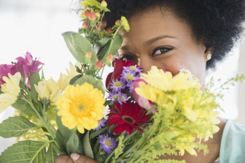 African American woman holding bouquet of flowers
