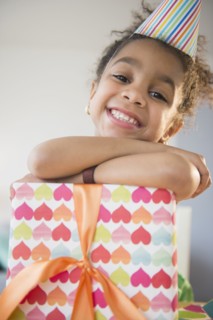 African American girl holding wrapped birthday gift