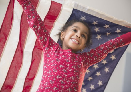 African American girl playing with United States flag