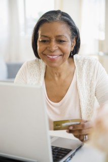 Mixed race woman shopping on laptop