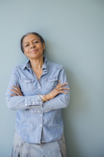 Mixed race woman standing with arms crossed