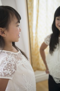 Filipino girl admiring herself in mirror