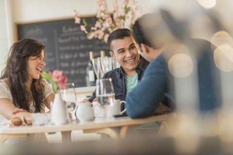 Hispanic friends talking in cafe