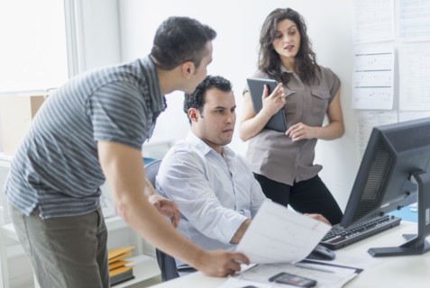 Hispanic business people working together in office